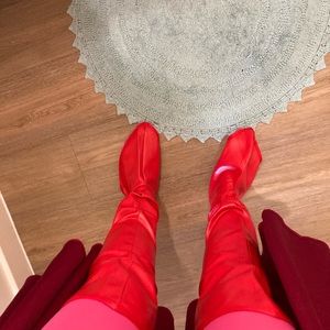 Red thigh high boot covers for costume or cosplay.